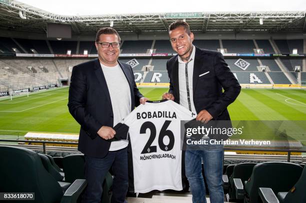 Director of Sport Max Eberl and Raul Bobadilla pose with his new shirt after he signs a new contract for Borussia Moenchengladbach at Borussia-Park...