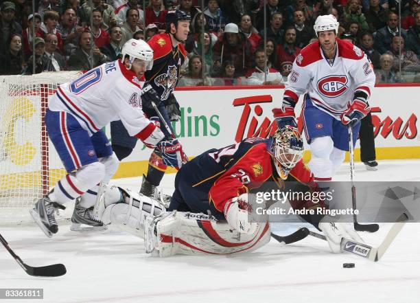 Tomas Vokoun of the Florida Panthers dives to cover a rebound against Maxim Lapierre of the Montreal Canadiens at the Bell Centre on October 20, 2008...