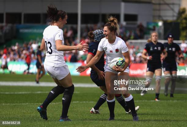 Amy Wilson Hardy celebrates with Emily Scarratt of England after scoring a try during the Women's Rugby World Cup Pool B match between England and...