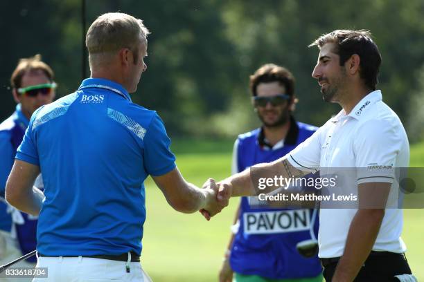 Mikko Ilonen of Finland shakes hands with Matthieu Pavon of France on the 11th green after winning his match during round one of the Saltire Energy...