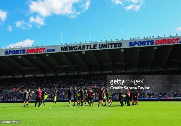 Newcastle players talk with manager Rafael Benitez during a Newcastle United Open Training session at St.James' Park on August 17 in Newcastle upon...