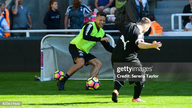 Dwight Gale of Newcastle United has a kick about with disabled footballers during a Newcastle United Open Training session at St.James' Park on...