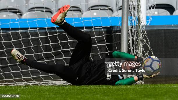 Goalkeeper Freddie Woodman dives for the ball during a Newcastle United Open Training session at St.James' Park on August 17 in Newcastle upon Tyne,...