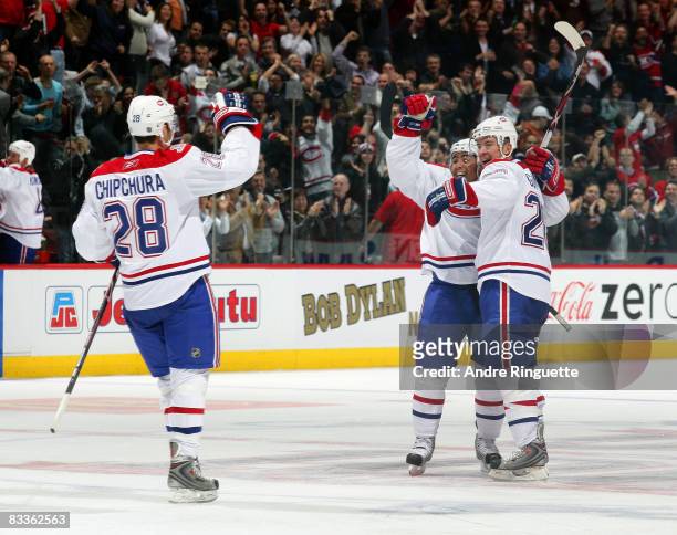 Francis Bouillon of the Montreal Canadiens celebrates his game winning goal against the Florida Panthers with teammates Kyle Chipchura and Josh...