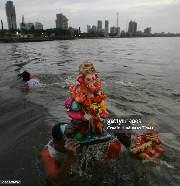 Ganpati Visarjan: Volunteers escorts the city's favorite God into the sea at Dadar Chowpatty on Monday.
