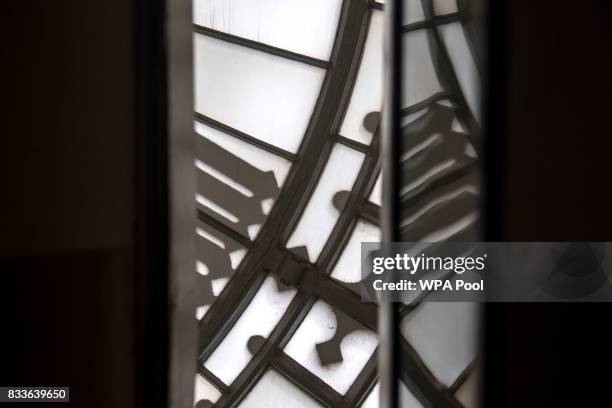 One of the four clockfaces of Big Ben is reflected within an internal window in the mechanism room of Elizabeth Tower ahead of the bell ceasing to...