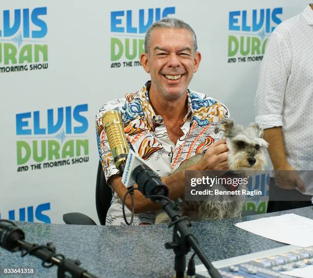 Radio personality Elvis Duran poses for a picture with his dog Alex during the "The Elvis Duran Z100 Morning Show" at Z100 Studio on August 17, 2017...