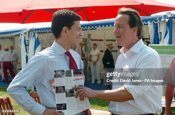 Conservative party leader David Cameron meets Britain's Environment Secretary David Miliband during a visit to the Royal Show at , Stoneleigh,...