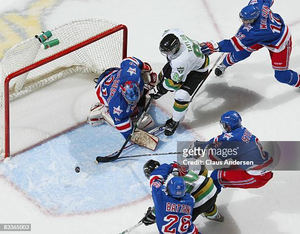Parker Van Buskirk of the Kitchener Rangers stops a scoring attempt by Justin Taylor of the London Knights in a game against the London Knights on...