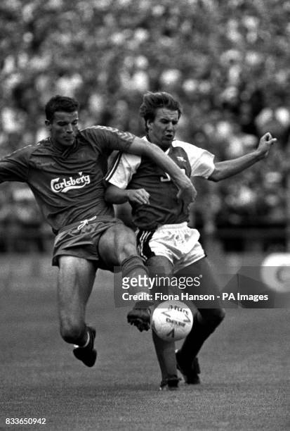 Wimbledon's Peter cawley and Arsenal's Paul Merson battle for the ball. Arsenal went on to win 5-1, with Merson putting away his teams final goal...