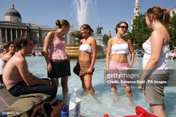 Nick Roberts, Sarah Collett, Lucy Moore, Laura Harman and Lucy Dean cool off in a Trafalgar Square fountain, in central London as temperatures soar...