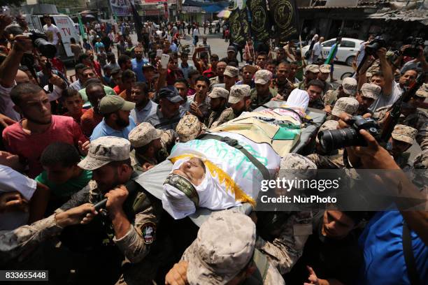 Mourners and Hamas militants carry the body of Nidal al-Jaafari, a 28-year-old field commander who was killed overnight in a suicide attack that...