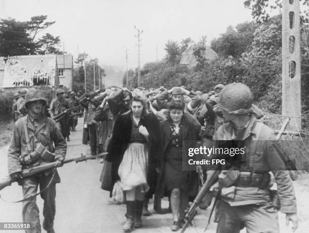 American soldiers with prisoners of war after the Battle of Cherbourg, France, June 1944.