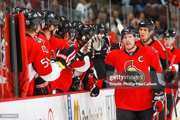 Daniel Alfredsson and Filip Kuba of the Ottawa Senators skate by the bench to celebrate a goal during the game against the Phoenix Coyotes on October...