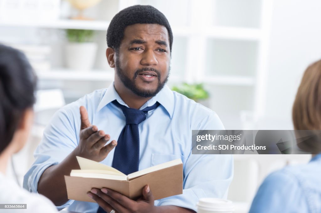 Serious man leads Bible study at work