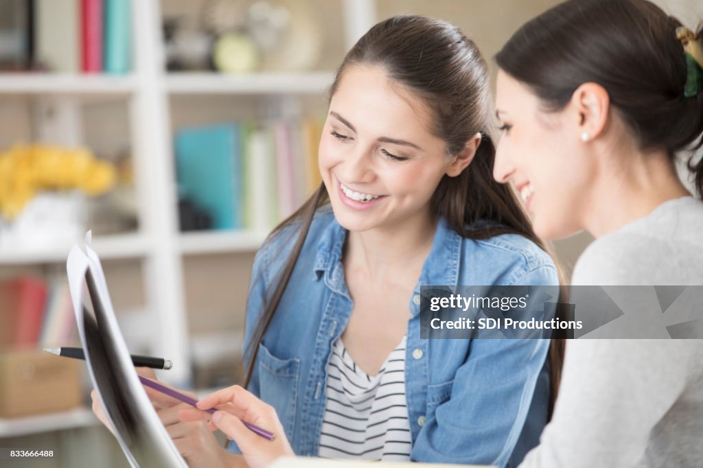 Businesswomen review documents together