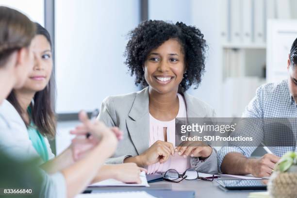 attentive ceo listens to colleague during meeting - company president stock pictures, royalty-free photos & images