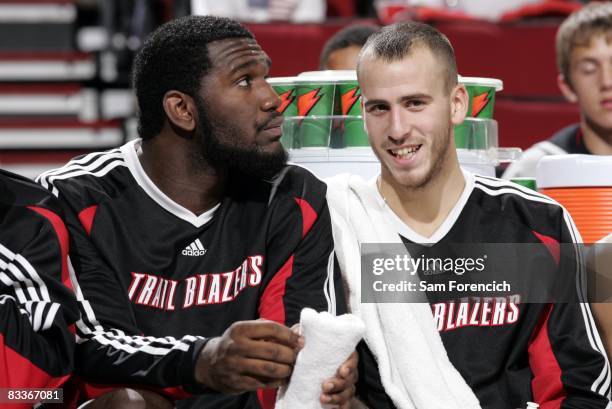 Greg Oden and Sergio Rodriguez of the Portland Trail Blazers watch the action from bench during the game against the Utah Jazz at the Rose Garden...