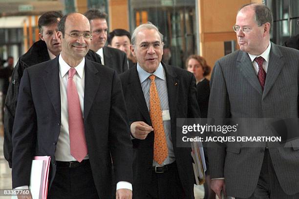 French Budget Minister Eric Woerth, OECD General Secretary Angel Gurria and German Federal Minister of Finance Peer Steinbrueck walk at the French...