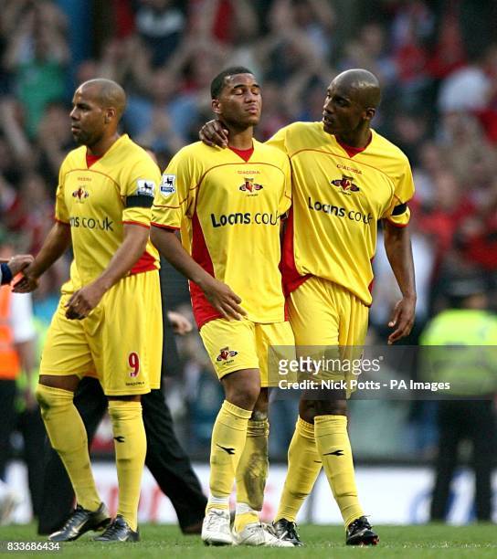 Adrian Mariappa is consoled by Damien Francis and Marlon King