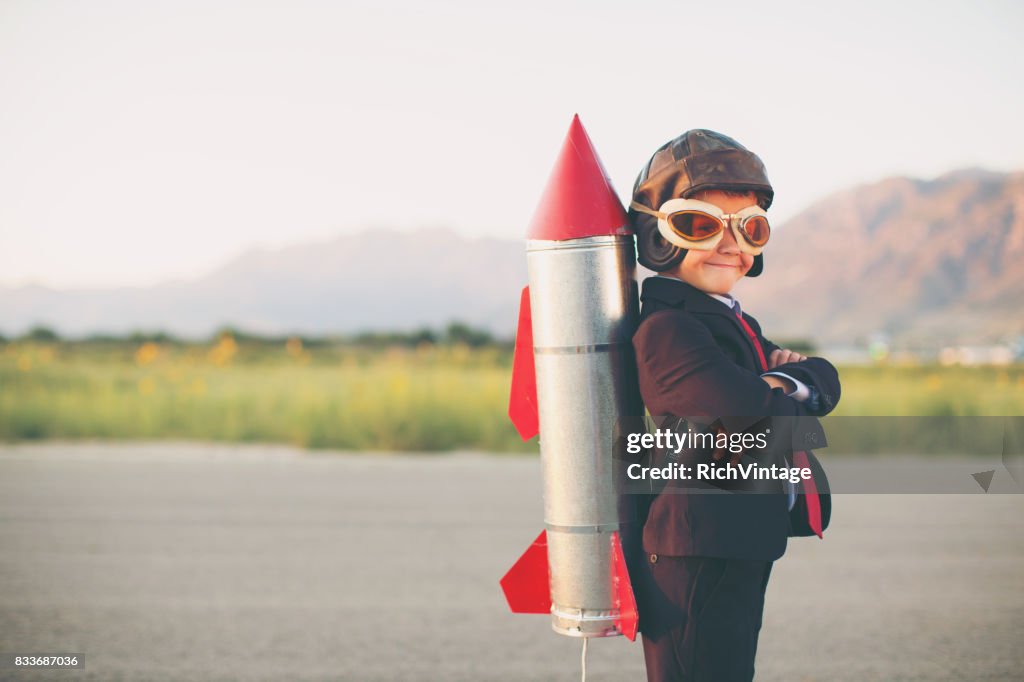 Young Business Boy with Rocket on Back