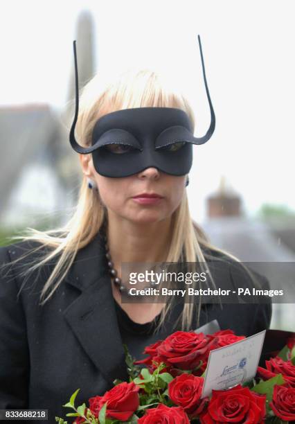 Mourner attends Isabella Blow's funeral service at Gloucester Cathedral.