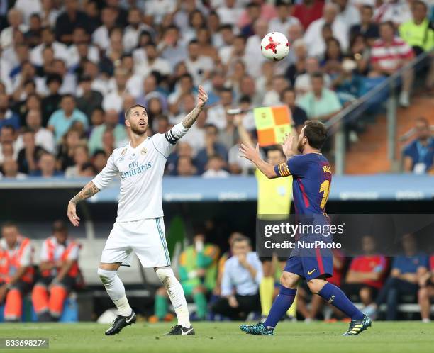 Sergio Ramos of Real Madrid CF throws the ball in the air beside Lionel Messi of FC Barcelona after Barcelona were awarded a free kick during the...