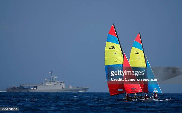 The two Indonesian teams race side by side during the Hobbie 16 class sailing on day four of the Asian Beach Games at Serangan Island on October 21,...