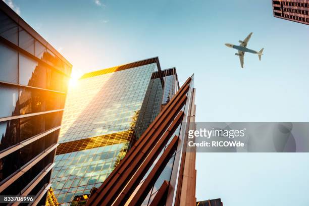 skyscraper with a airplane silhouette - light burst abstract centre stock-fotos und bilder