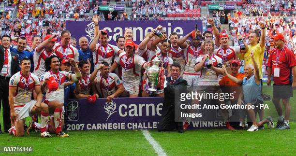 St Helens players celebrate their victory following the Carnegie Challenge Cup Final at Wembley Stadium, London.