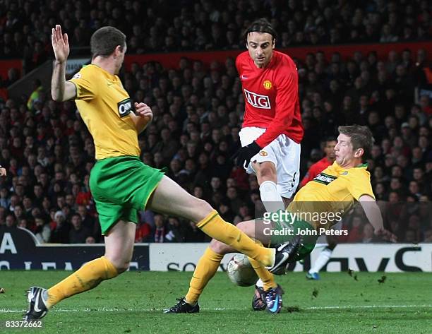 Dimitar Berbatov of Manchester United clashes with Mark Wilson of Celtic during the UEFA Champions League Group E match between Manchester United and...
