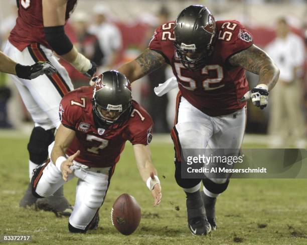 Quarterback Jeff Garcia of the Tampa Bay Buccaneers reaches for a loose football against the Seattle Seahawks at Raymond James Stadium on October 19,...