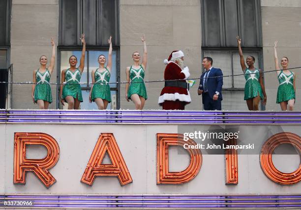 Man in Santa Claus costume and PLJ announcer John Foxx along with the Rockettes pose as The Radio City Rockettes Christmas In August 2017 perform on...