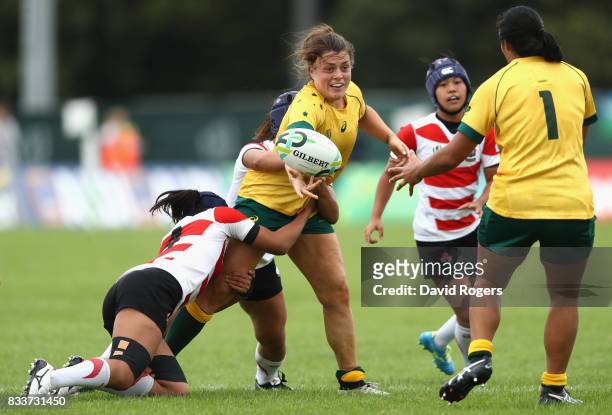 Grace Hamilton of Australia offloads the ball during the Women's Rugby World Cup Pool C match between Australia and Japan at Billings Park UCD on...