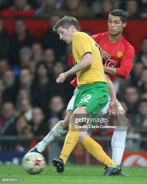 Cristiano Ronaldo of Manchester United clashes with Mark Wilson of Celtic during the UEFA Champions League Group E match between Manchester United...