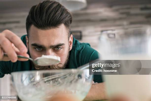 man cook measuring how much sugar he need - chef male kitchen stock pictures, royalty-free photos & images