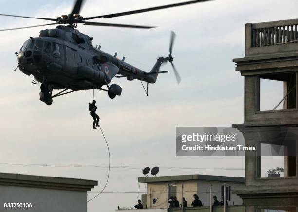 Mumbai Terror Attack: Military personnel abseiling from a helicopter. Special forces stormed a Jewish centre in Mumbai Friday as part of efforts to...