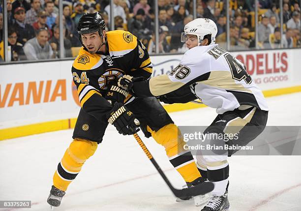 Shane Hnidy of the Boston Bruins skates after the puck against Tyler Kennedy of the Pittsburgh Penguins at the TD Banknorth Garden on October 20,...