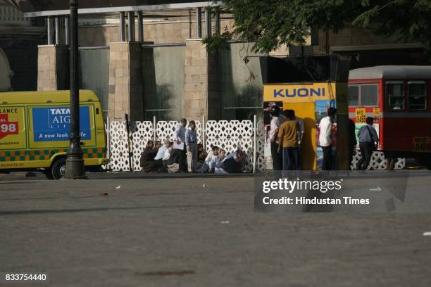 Mumbai Terror Attack: Hostages and guests of the Taj hotel takes shelter behind the wall to protect from the continues firing at Taj Hotel.