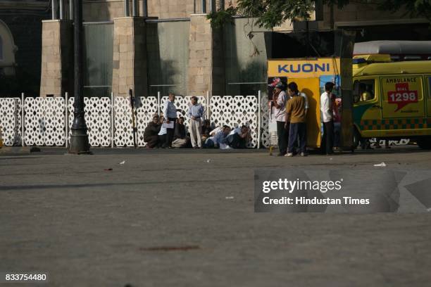 Mumbai Terror Attack: Hostages and guests of the Taj hotel takes shelter behind the wall to protect from the continues firing at Taj Hotel.