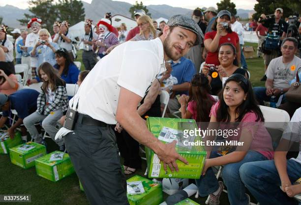 Justin Timberlake hands out Xbox 360 video game consoles to youth from Shriners Hospitals during a golf clinic for kids during the Justin Timberlake...