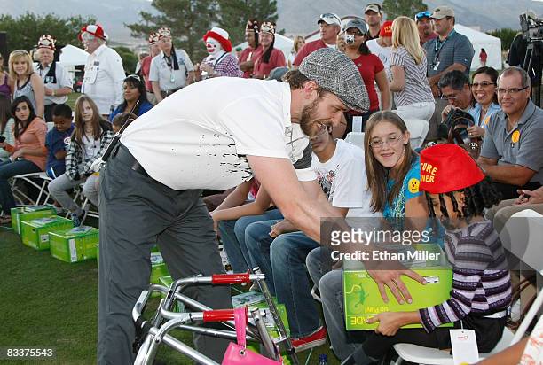 Justin Timberlake hands out Xbox 360 video game consoles to youth from Shriners Hospitals during a golf clinic for kids during the Justin Timberlake...