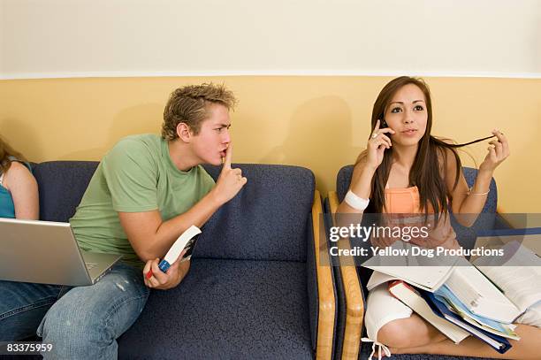 college coed trying to silence  girl on cell phone - social grace stock pictures, royalty-free photos & images