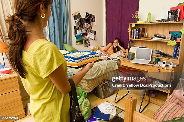 mom bringing birthday cake to daughter's dorm room - collegebasket stock pictures, royalty-free photos & images