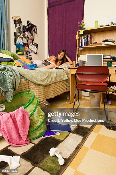 college student studying in messy dorm room - basket universitario imagens e fotografias de stock