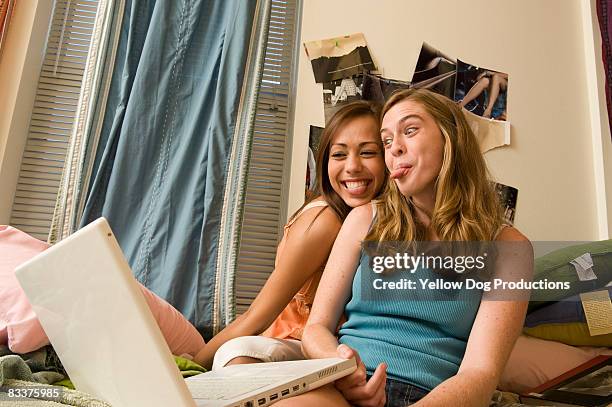 college roommates sharing a goofy moment in dorm - blonde girl sticking out her tongue stock pictures, royalty-free photos & images