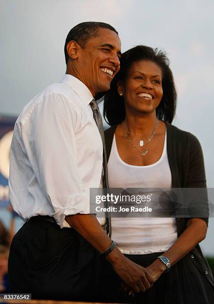 Democratic presidential nominee Barack Obama stands with his wife Michelle Obama during a campaign rally October 21, 2008 in Miami, Florida. Obama...