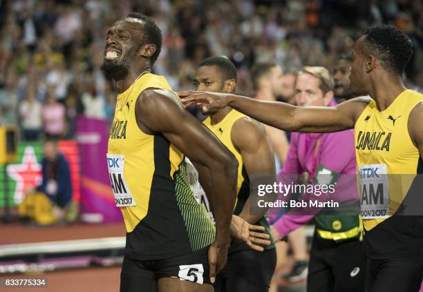 16th IAAF World Championships: Jamaica Usain Bolt grimacing in pain with teammates during injury during Men's 4X100M Final race at Olympic Stadium....