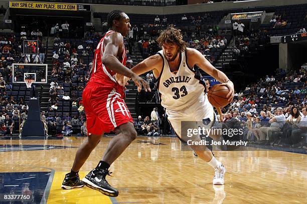 Marc Gasol of the Memphis Grizzlies drives to the basket againt Joey Dorsey of the Houston Rockets during the game at the FedExForum on October 15,...