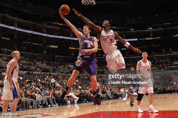 Goran Dragic of the Phoenix Suns has his shot contested by Ricky Davis of the Los Angeles Clippers at Staples Center on October 21, 2008 in Los...
